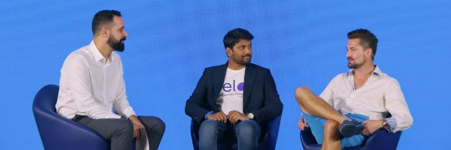 David Burrells in conversation on stage with two other speakers